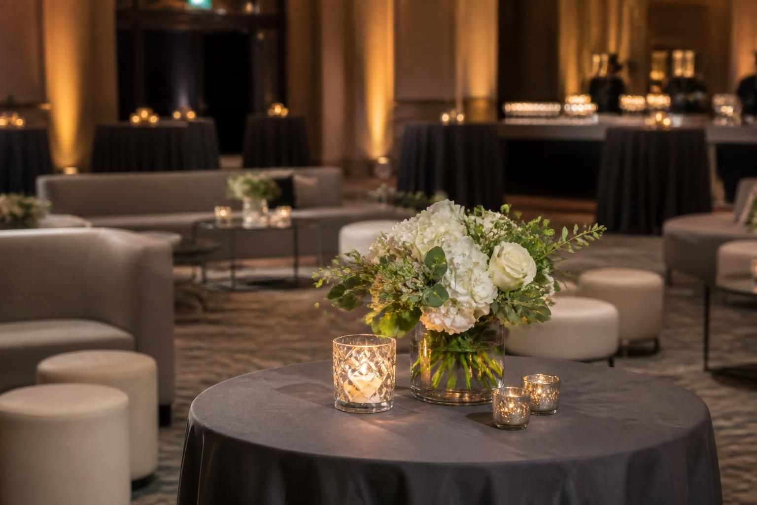 Corporate gala reception with modern seating and elegant centerpieces.